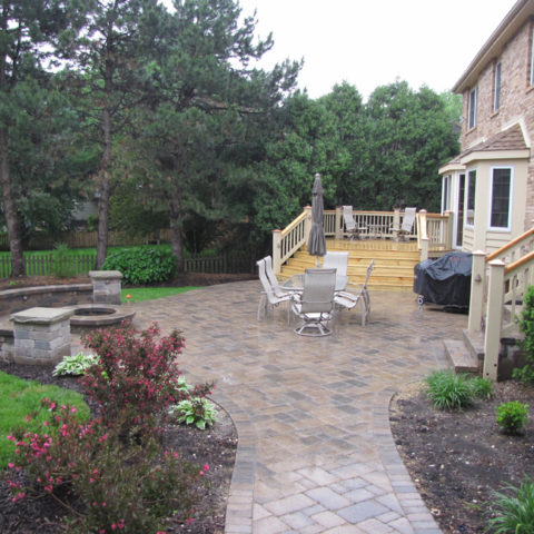 Stone patio, deck and circle fireplace